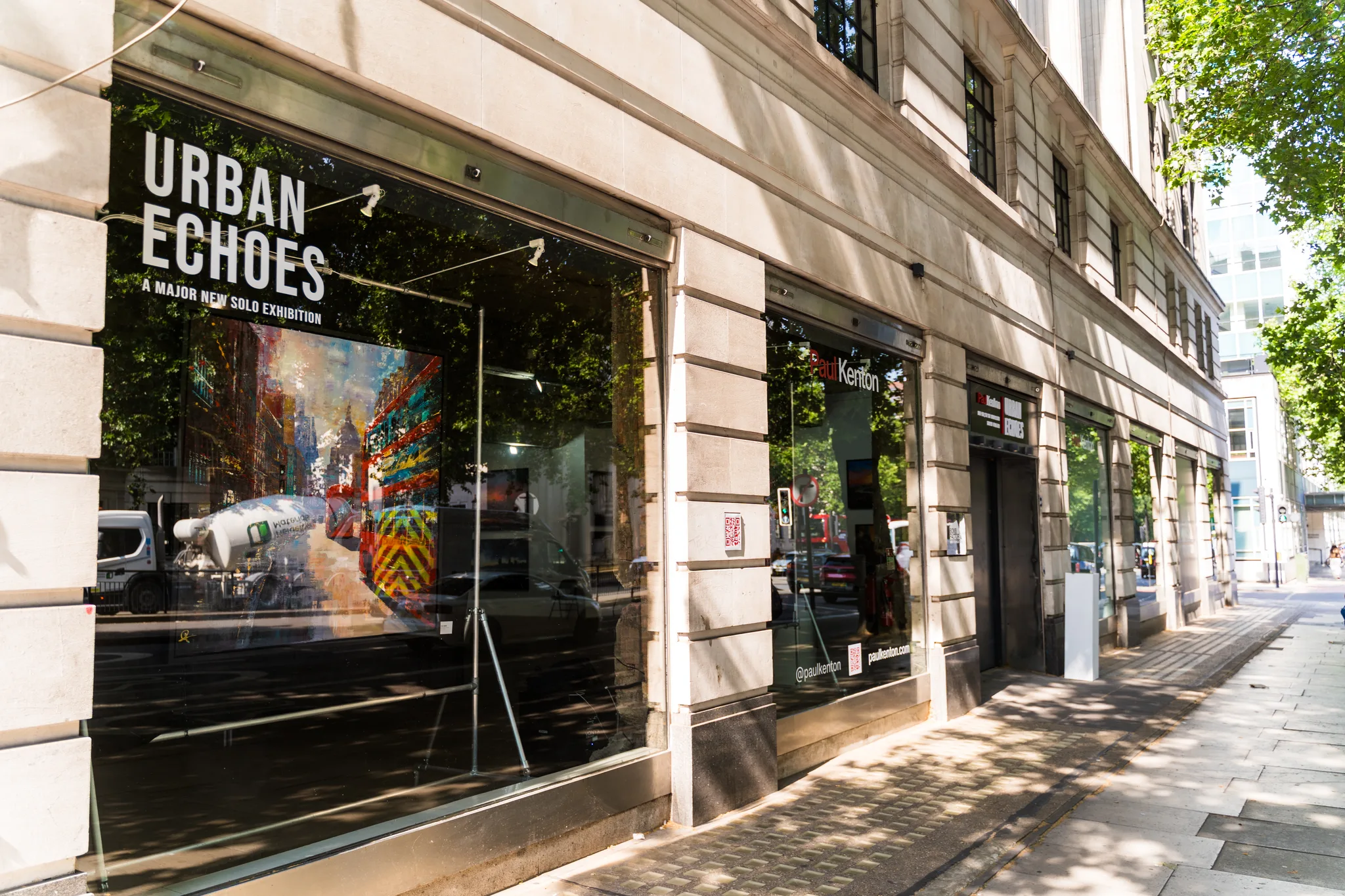 A sunlit shopfront on Marylebone Road, its large window lettered Urban Echoes next to a bright city painting.