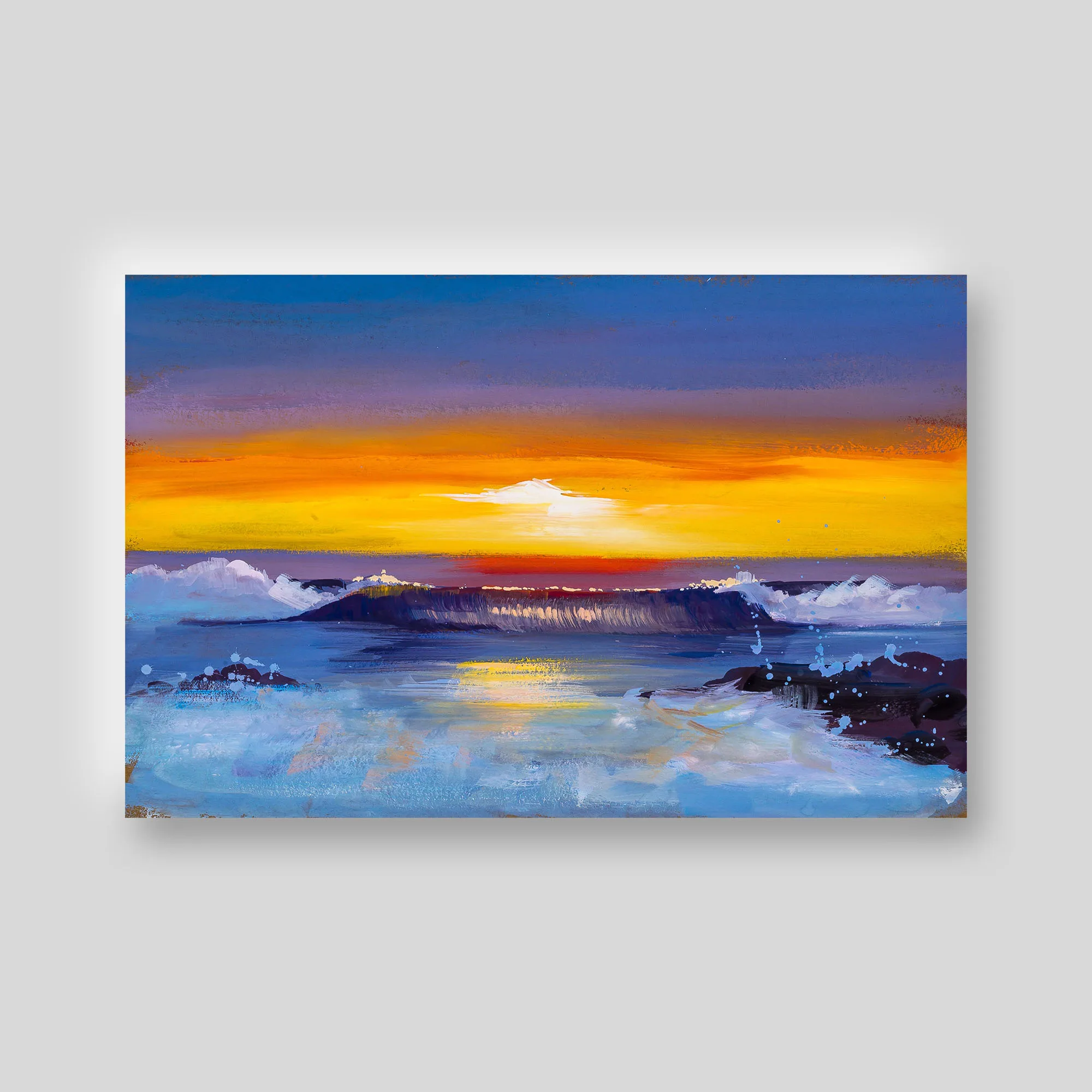 Beach Sunsets print: a bold orange sunset over a dark headland, with blue sky above and pale, splashing sea below.