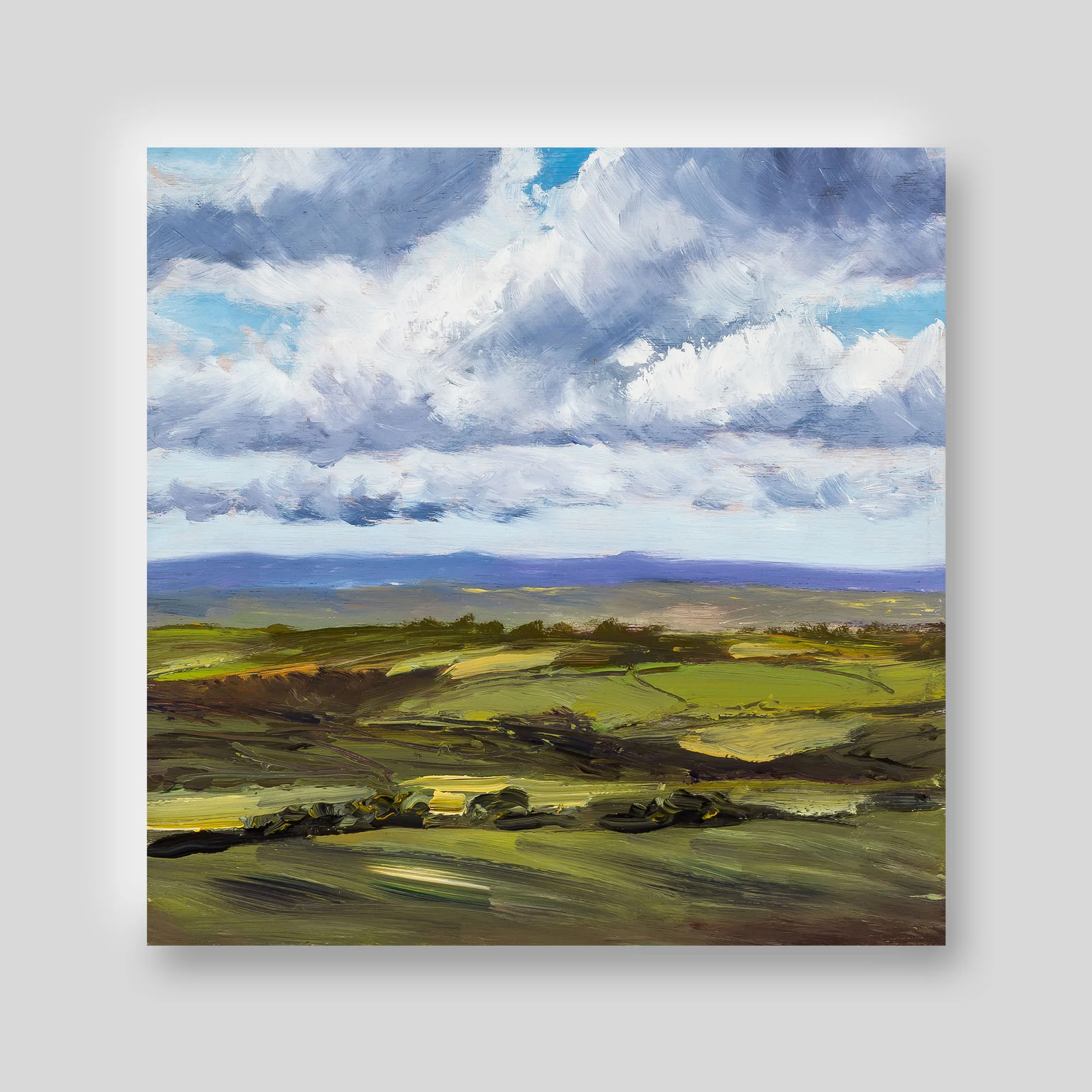 Detail of a Paul Kenton landscape print: thick, bold brushstrokes of billowing grey-white clouds over a blue sky, with a purple hill range and green fields below.