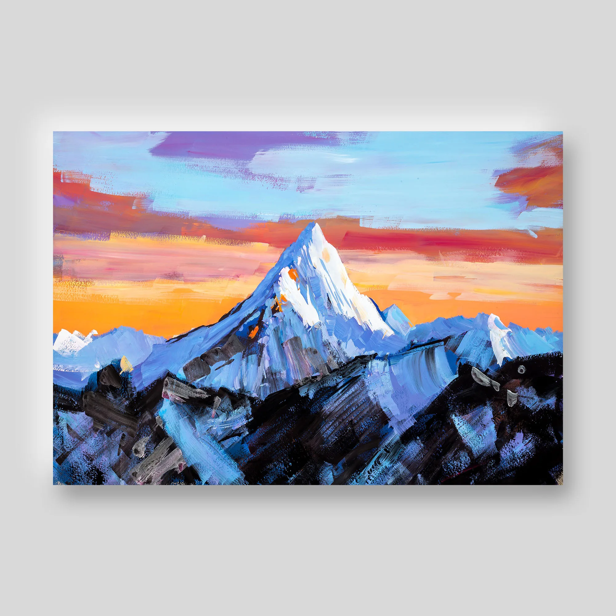 Close-up of a print from the Mountainscapes collection showing a snow-capped peak at sunset, with bold textured brushwork in blue, orange and violet against dark rocky slopes.