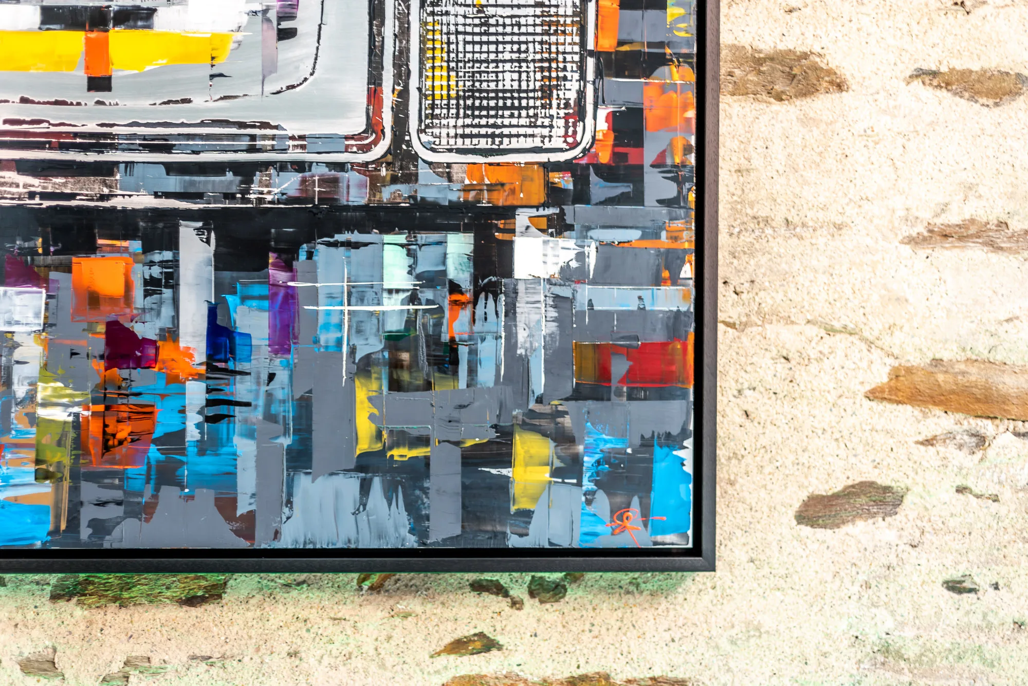 Close-up of the lower corner of Test Card TV, an original mixed media painting by Paul Kenton on aluminium, showing layered grey, blue, orange and yellow blocks of paint in a black frame.
